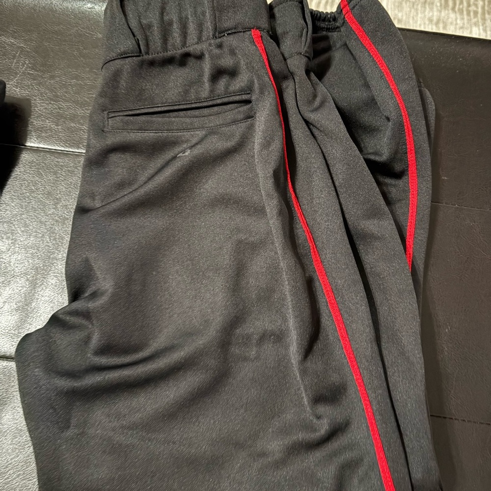 Women's Black Softball pants with Red Stripe. Size small.